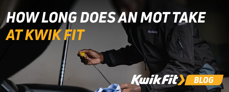 A Kwik Fit technician opening up a car bonnet