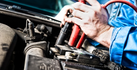 Man opening car bonnet to check battery