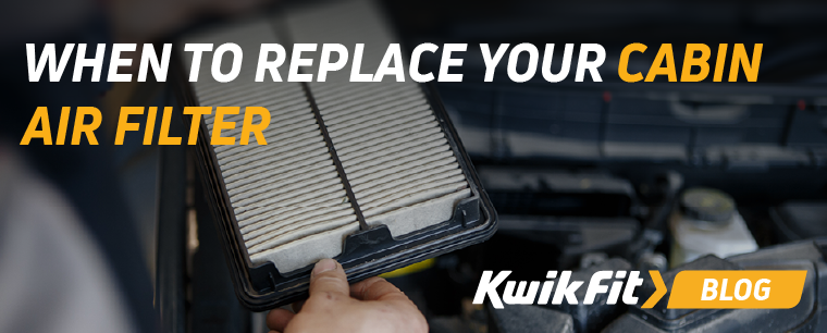 A person holding an air filter with the bonnet open